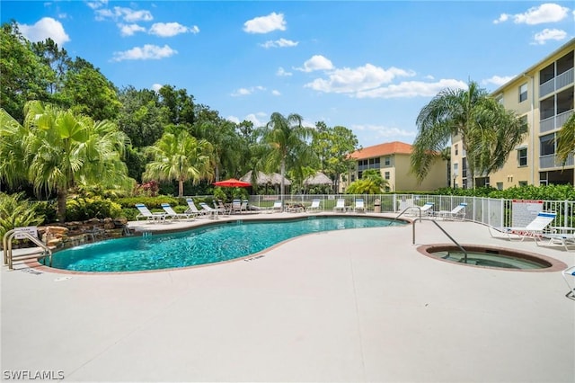 view of pool with a patio area and a hot tub