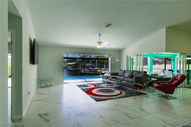 living room featuring ceiling fan and lofted ceiling