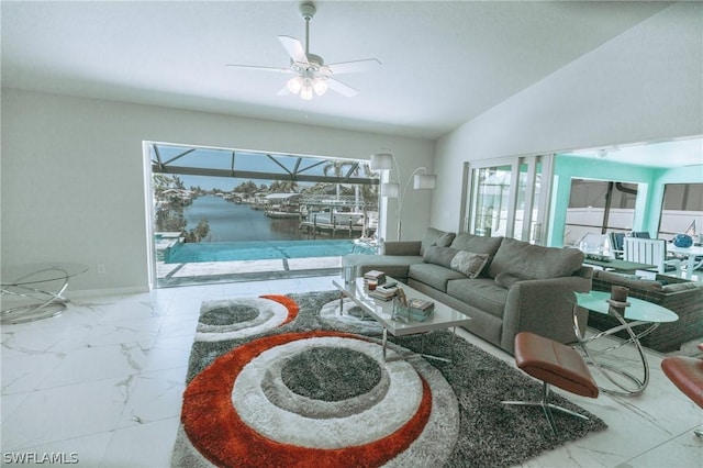 living room with a water view, vaulted ceiling, and ceiling fan