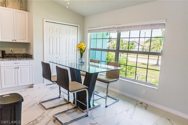 dining area featuring lofted ceiling