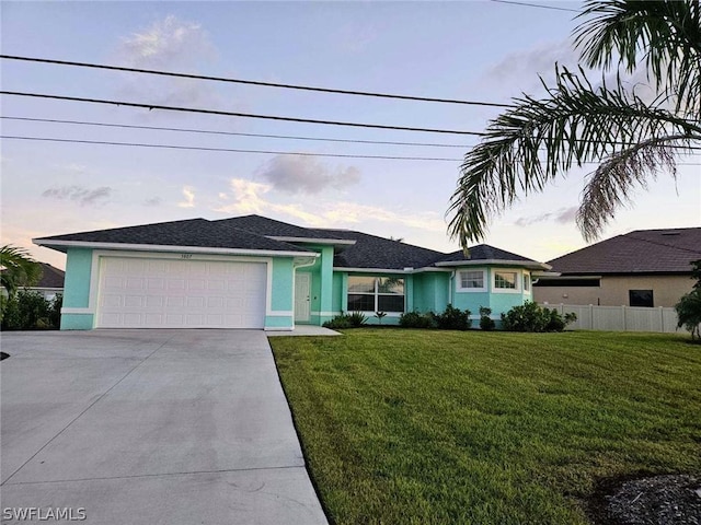 view of front of property with a lawn and a garage