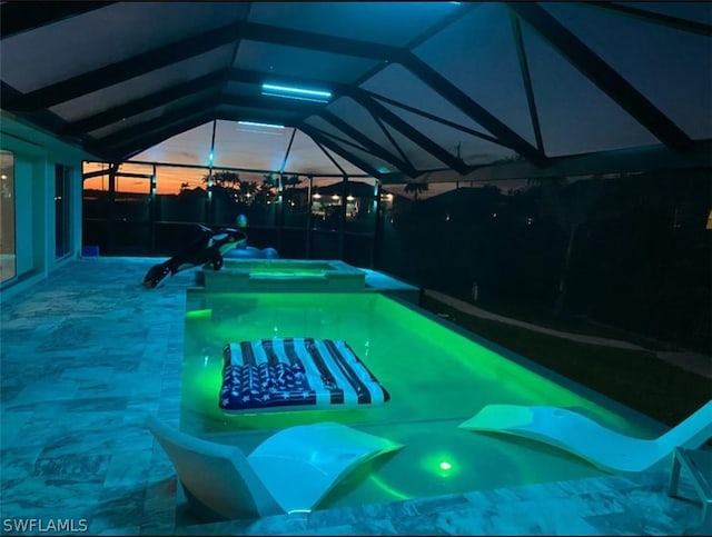 view of swimming pool featuring a lanai