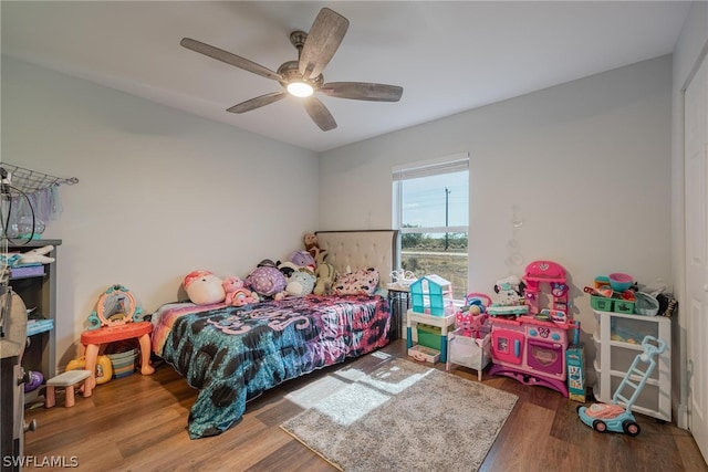 bedroom with ceiling fan and hardwood / wood-style floors