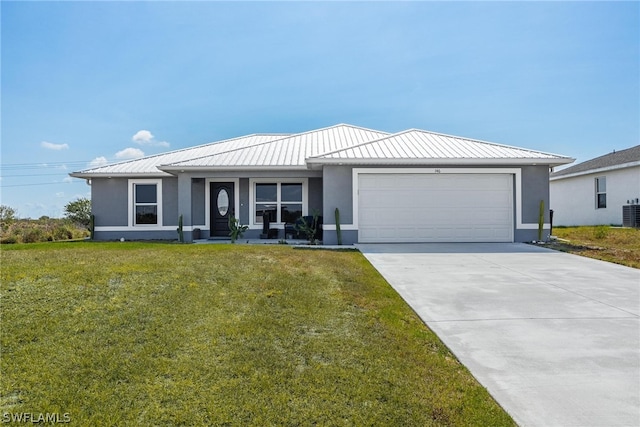 view of front of house with a front yard, a garage, and central air condition unit