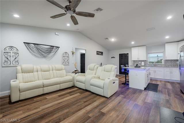 living room featuring dark wood-type flooring, ceiling fan, and lofted ceiling