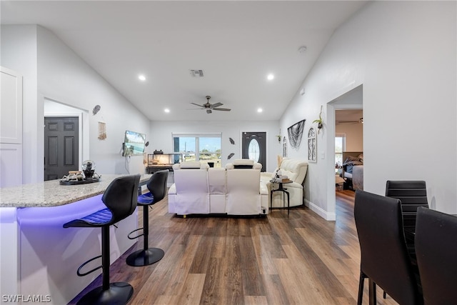 interior space with dark hardwood / wood-style floors, ceiling fan, and lofted ceiling