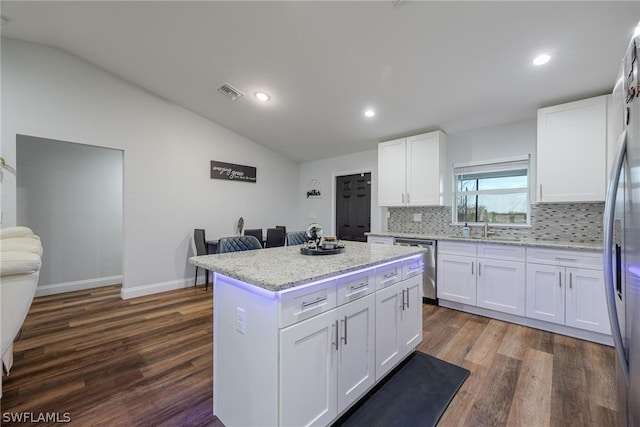 kitchen with lofted ceiling, dark wood-type flooring, and stainless steel appliances