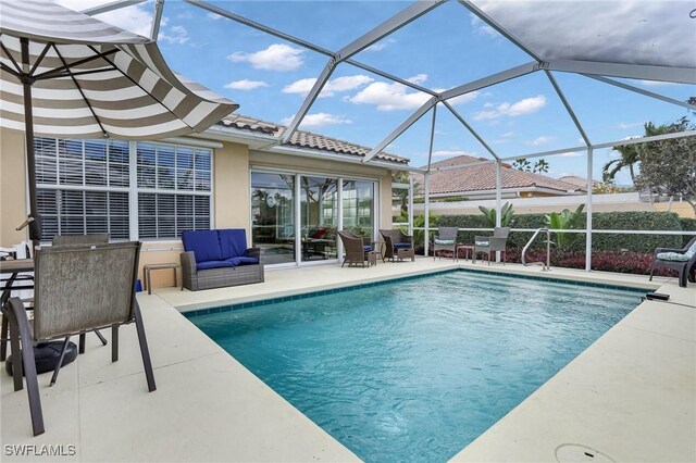 view of pool featuring a patio area and glass enclosure