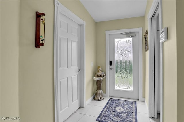 doorway to outside with light tile patterned flooring