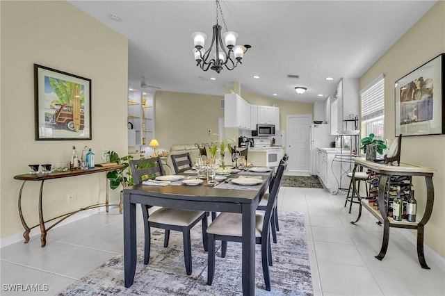 dining space featuring a notable chandelier and light tile patterned floors