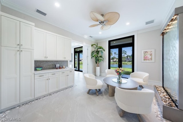 interior space with french doors, ornamental molding, ceiling fan, and light tile floors