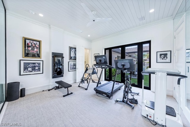 exercise room featuring a wealth of natural light, light carpet, and ornamental molding