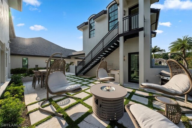 view of terrace with a fire pit