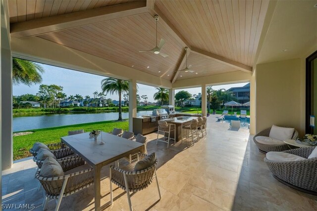 view of patio featuring a grill, ceiling fan, and a water view