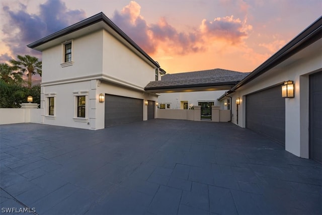 property exterior at dusk with a garage