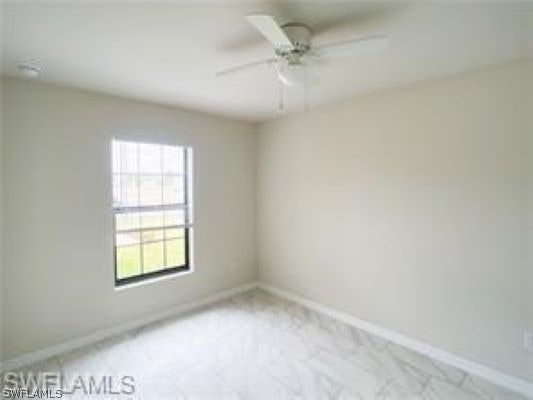 carpeted empty room with ceiling fan