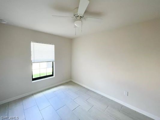 spare room with ceiling fan