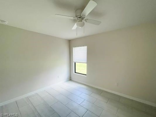 unfurnished room with ceiling fan