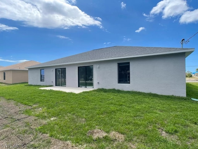 back of property featuring a patio and a lawn