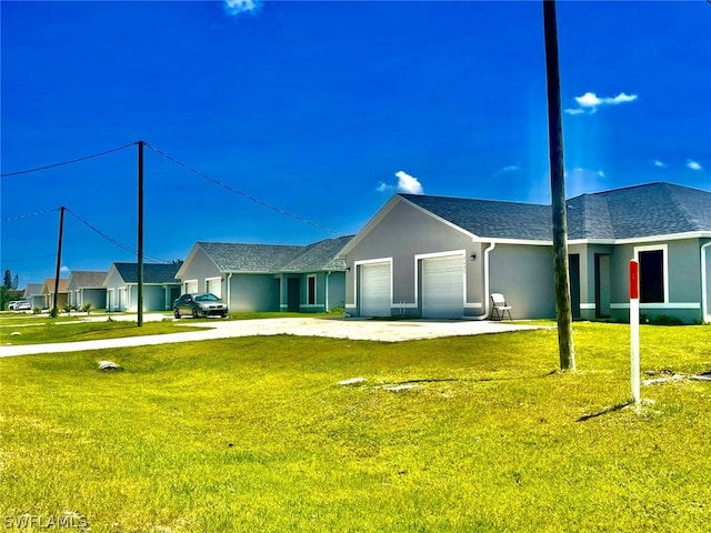 ranch-style house featuring a front yard and a garage