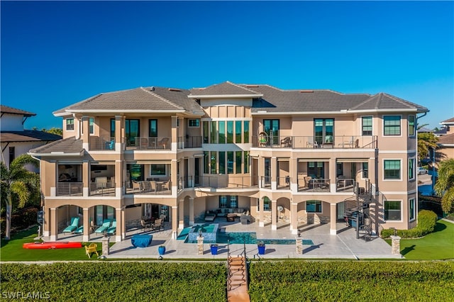 rear view of house featuring an outdoor hangout area and a patio