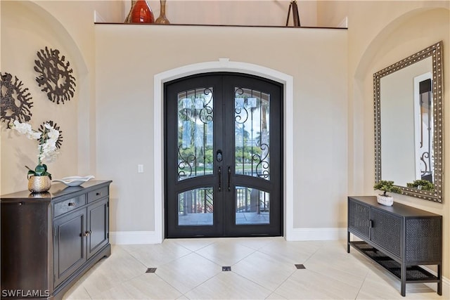 tiled entrance foyer featuring french doors