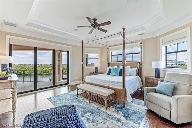 bedroom with multiple windows, ceiling fan, and dark hardwood / wood-style floors