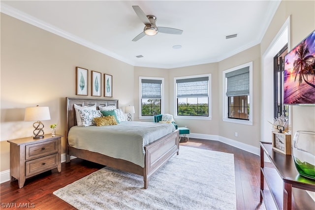 bedroom featuring dark hardwood / wood-style floors, ceiling fan, and crown molding