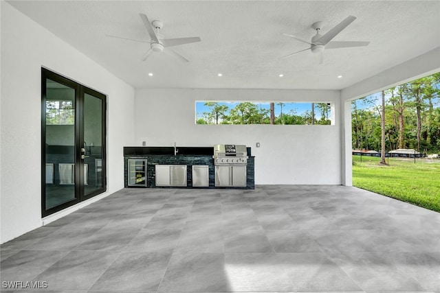 view of patio with ceiling fan, wine cooler, sink, and exterior kitchen