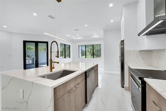 169 18th Ave NW, Naples, FL 34120 - kitchen with a sink, wall chimney exhaust hood, stainless steel appliances, modern cabinets, and recessed lighting