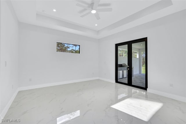 169 18th Ave NW, Naples, FL 34120 - empty room with french doors, plenty of natural light, marble finish floor, and a raised ceiling