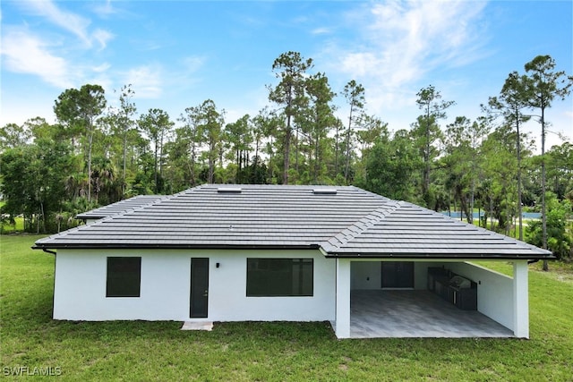 rear view of house featuring a yard