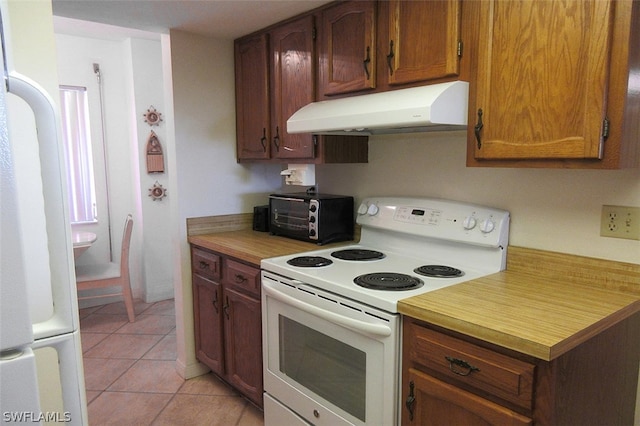 kitchen with white appliances and light tile floors