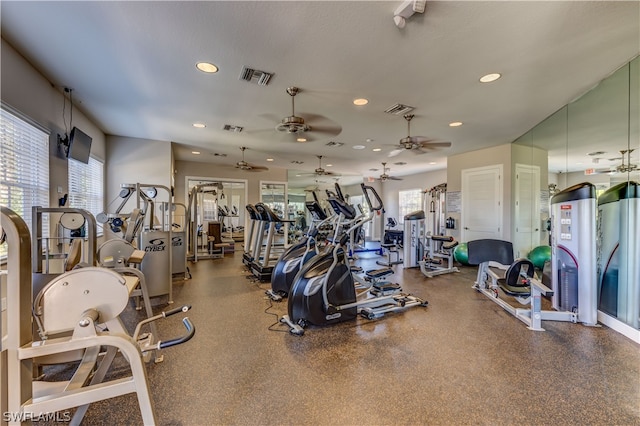 exercise room with a wealth of natural light and ceiling fan