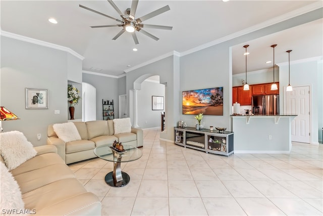 tiled living room with ceiling fan and crown molding