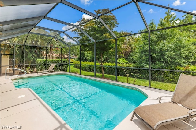 view of swimming pool featuring a patio and glass enclosure