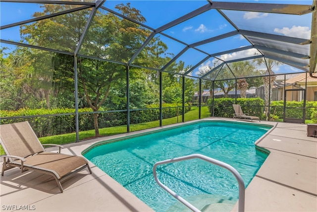 view of swimming pool featuring a lanai and a patio area