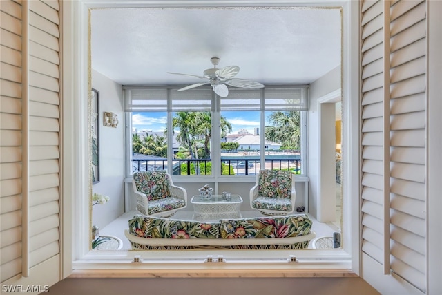 unfurnished sunroom featuring ceiling fan