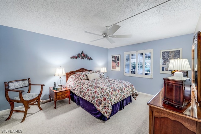 bedroom with light carpet, a textured ceiling, and ceiling fan