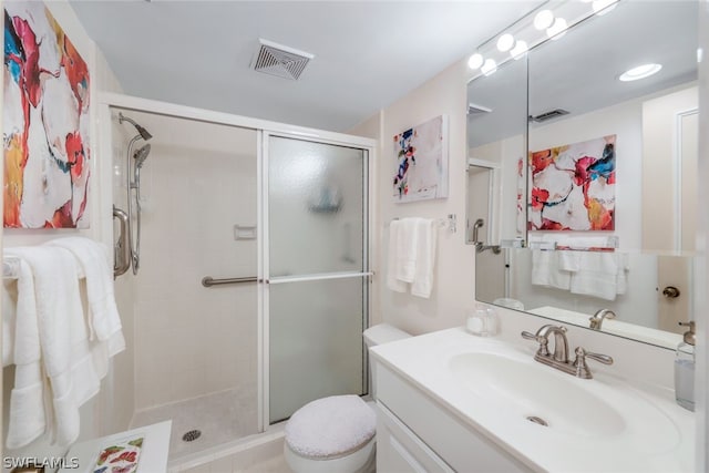 bathroom with vanity, toilet, and walk in shower