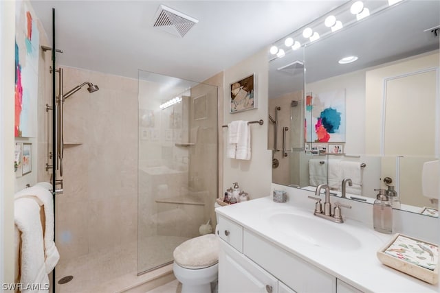 bathroom with vanity, an enclosed shower, and toilet