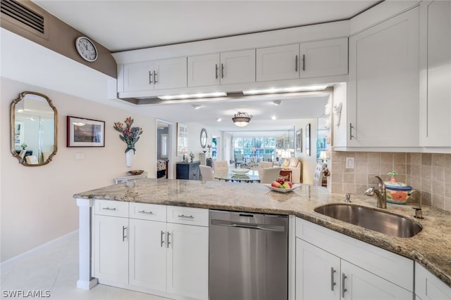 kitchen featuring white cabinetry, stainless steel dishwasher, and sink