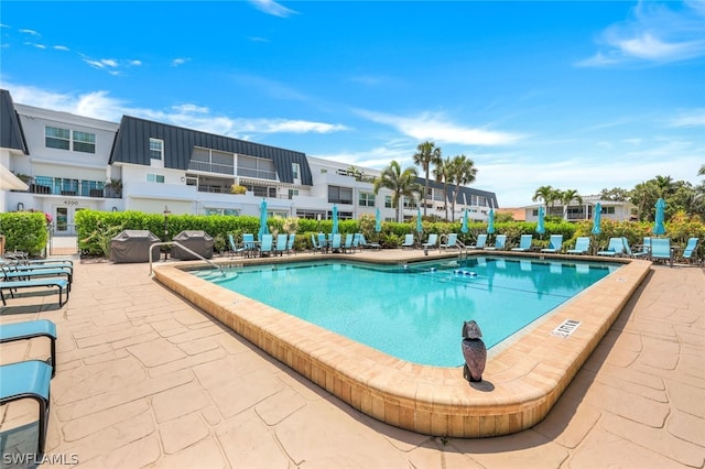 view of swimming pool with area for grilling and a patio area