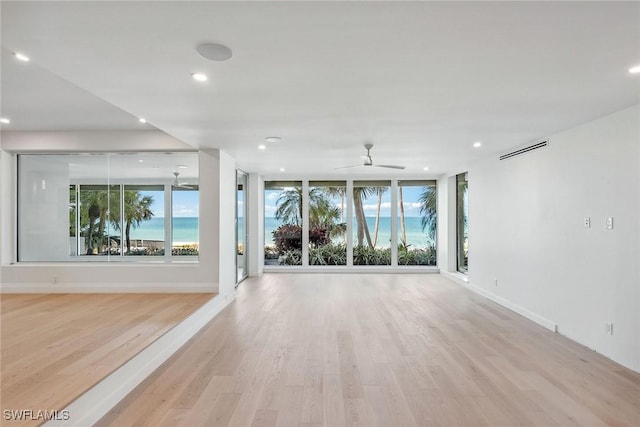 spare room with ceiling fan and light hardwood / wood-style floors