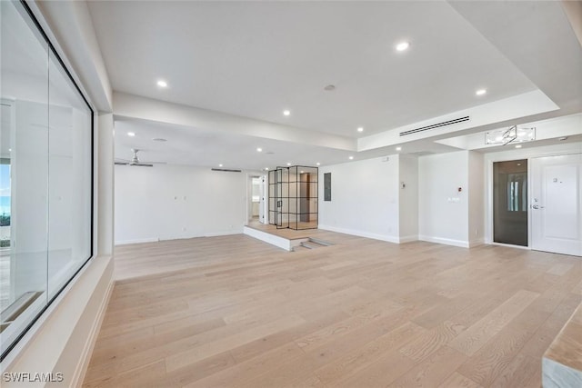 unfurnished room with ceiling fan and light hardwood / wood-style floors