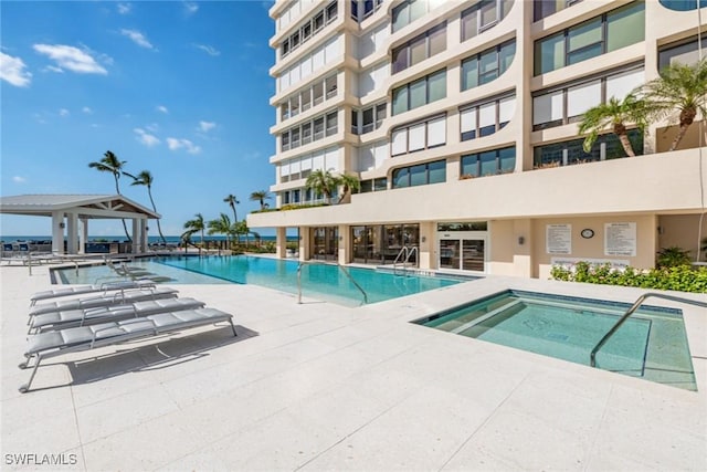 view of pool with a hot tub