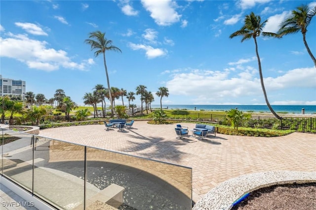 view of community featuring a water view and a patio