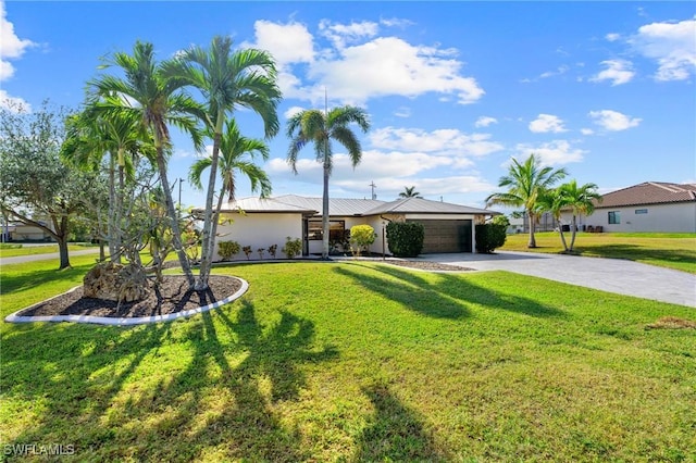 single story home featuring a garage and a front yard