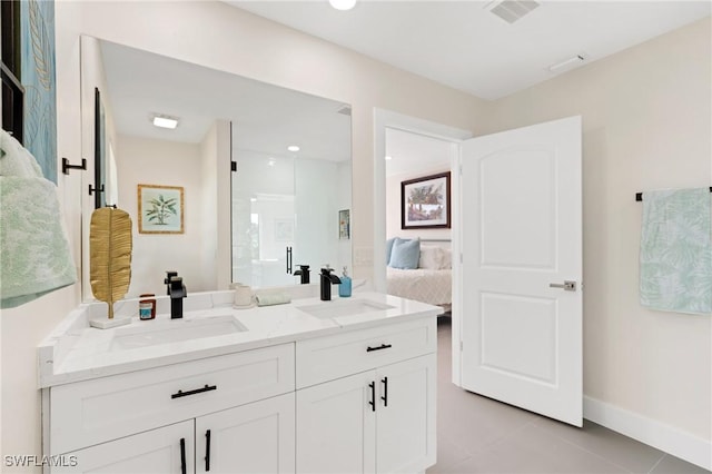 bathroom featuring tile patterned flooring, vanity, and a shower with door