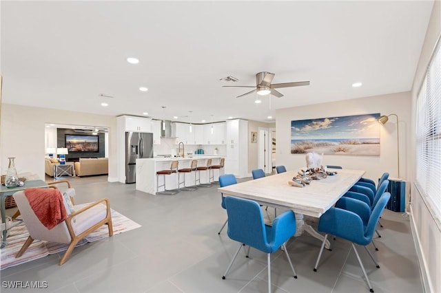 tiled dining area with sink and ceiling fan